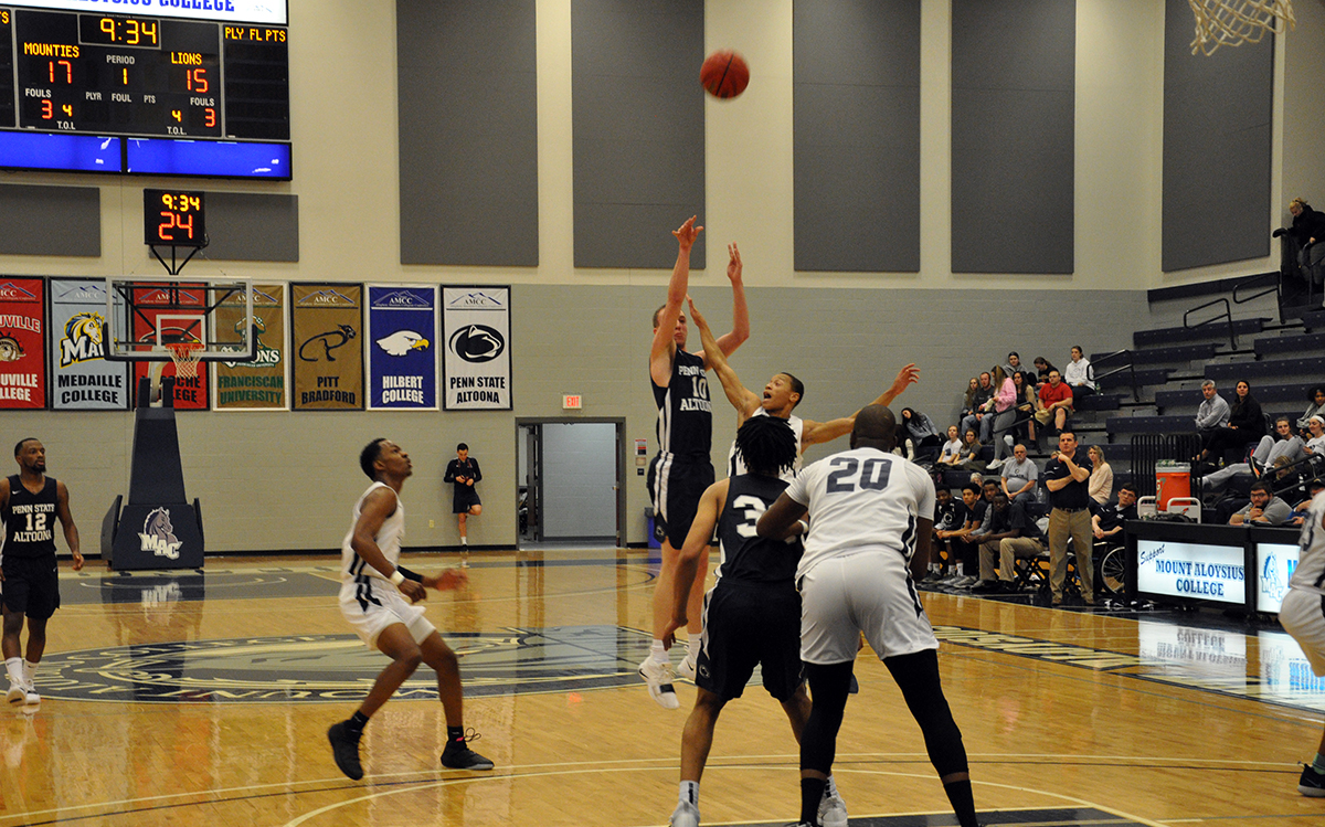 Photo: Senior forward Marshall Higley takes a three-pointer during Wednesday night's loss at Mount Aloysius College.