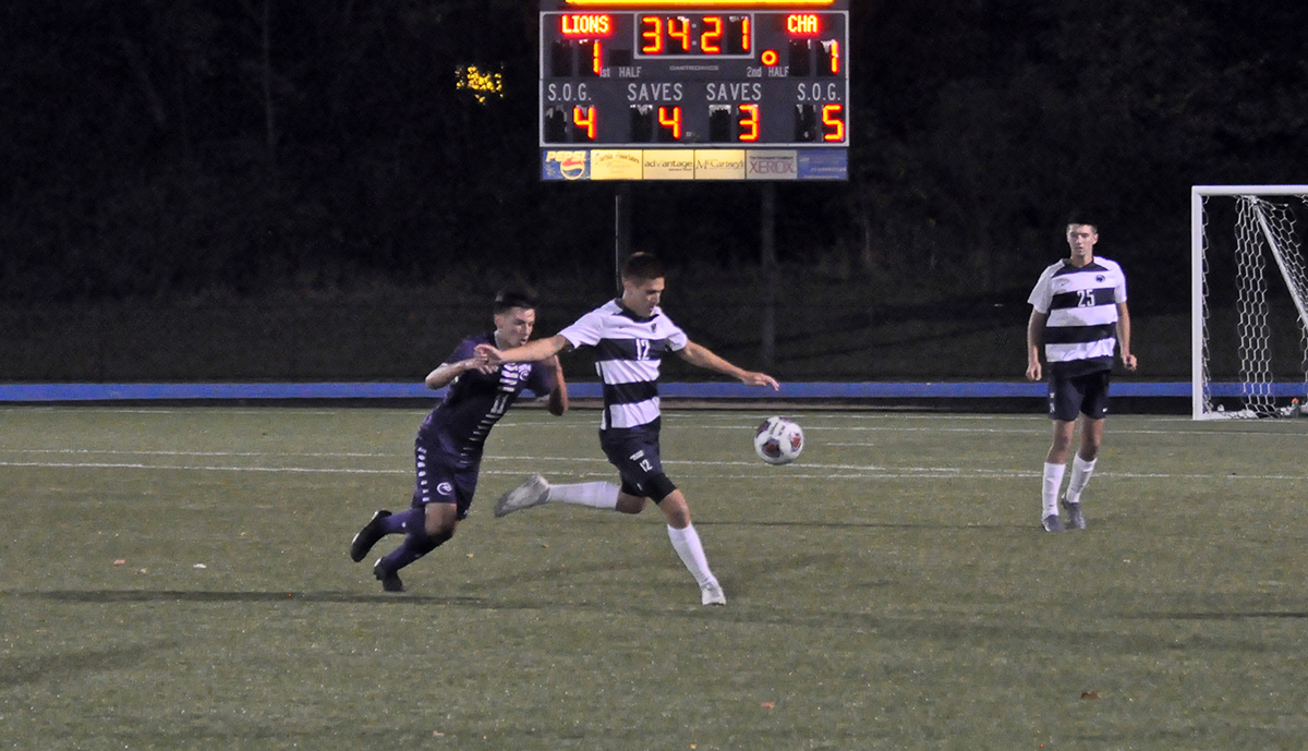 Photo (by Omer Sanchez): Junior Evan Cardoza kicks the ball away from Chatham's Leandro Nasso during the second half of Wednesday night's game.