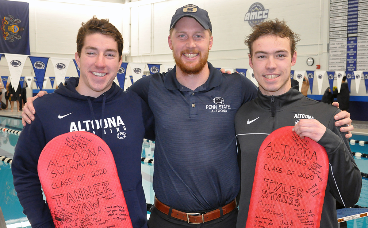Photo: Senior swimmers Tanner Yaw (left) and Tyler Stauss (right), joined by head coach Brad Brooks (center), were recognized in a pre-meet Senior Night ceremony on Friday.