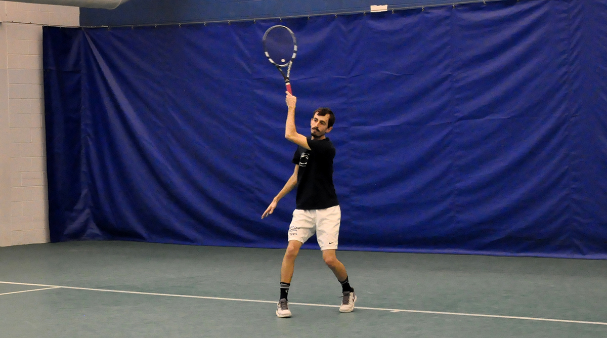 Photo: Senior Jonathan D'Arcy competes during his singles match against Waynesburg on Friday at The Summit.