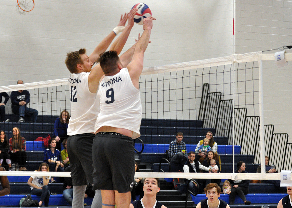 Photo (by Marina Zimmerman): Penn State Altoona seniors Dan Downs (left) and Justin Bannister (right) go up for a block during Tuesday night's match against Medaille in the Adler Arena.