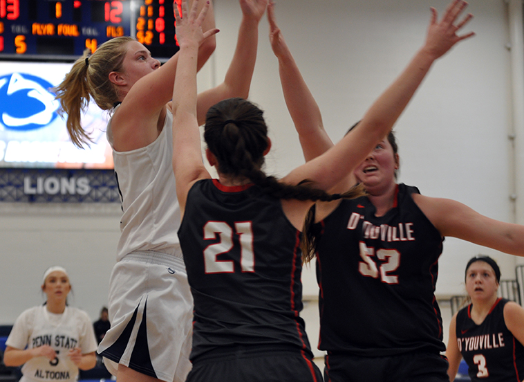 Photo (by Raychel DeArmitt): Freshman Alexis Cannistraci pulls up for a jumper in front of two D'Youville defenders during the Lady Lions' win in the Adler Arena on Saturday.