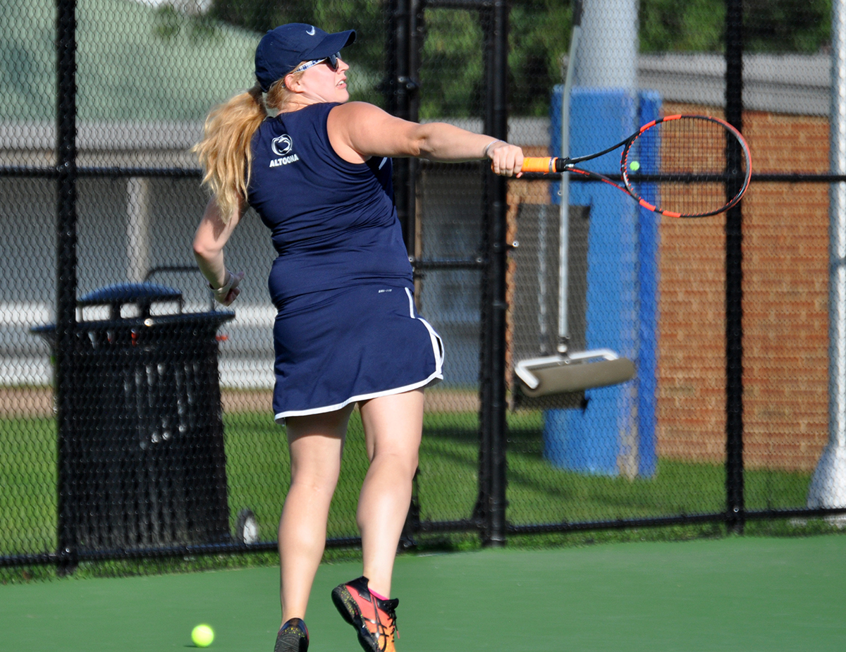Photo: Lady Lions junior Victoria Acker follows through on a backhand shot during her doubles match against Juniata on Monday at the Adler Tennis Courts.