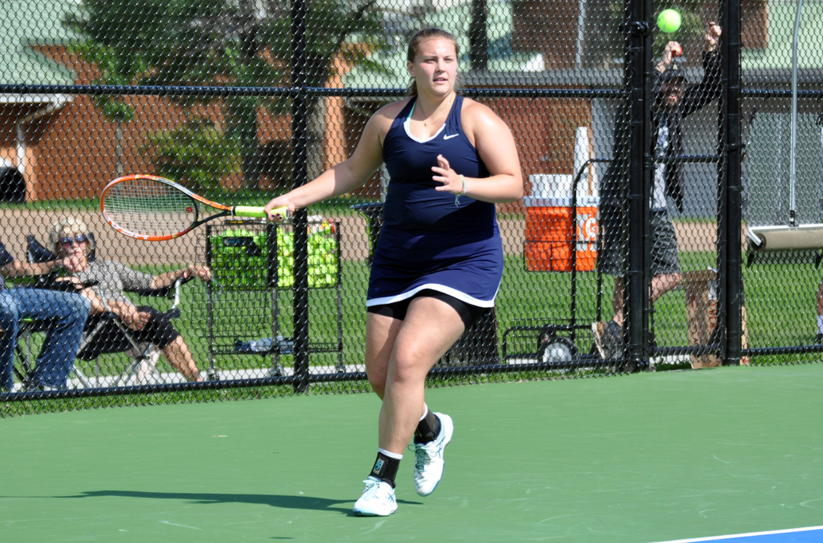 Photo: Junior Brayley Lewis hits a forehand shot during Sunday afternoon's match against Mount Aloysius College at the Adler Tennis Courts.