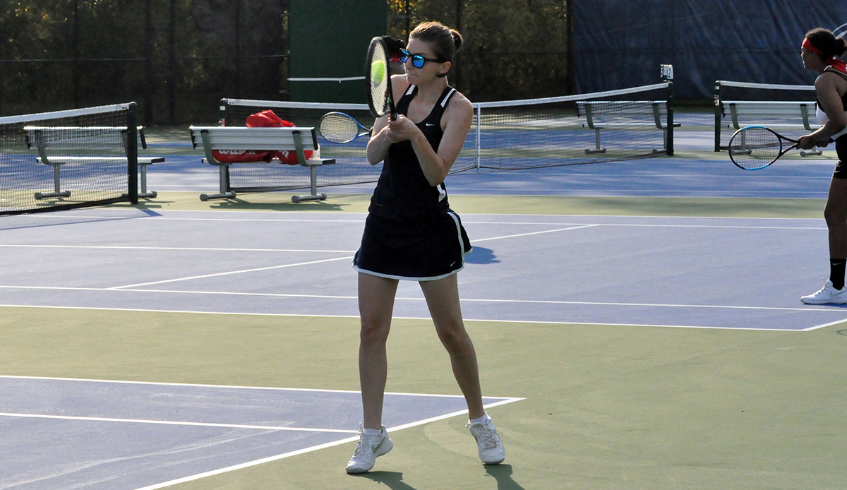 Photo: Junior Sophia Girol connects with the ball during her doubles match on Tuesday against La Roche.