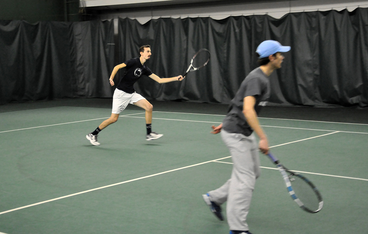 Photo: Jonathan D'Arcy (left) and Logan Kyle (right) compete during doubles play on Sunday against Penn State Behrend at the Gorilla House Gym.