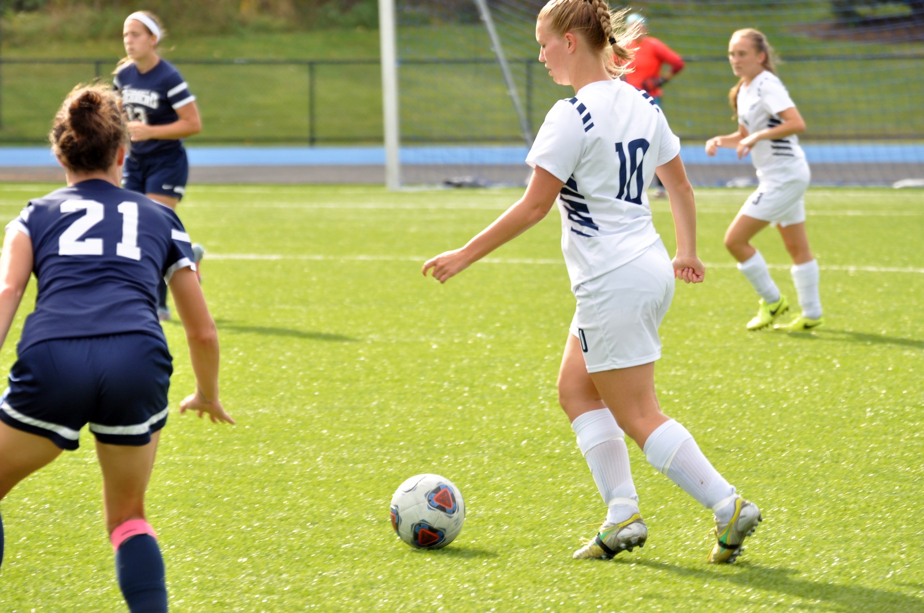 Photo (by Joel Nelson): Penn State Altoona freshman defender Rylee Duck looks to move the ball away from Penn State Behrend's #21 Sami Lowry during Saturday's game at Spring Run Stadium.
