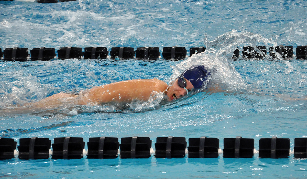 Photo: Freshman Gillian Lowe swims one leg of the 400 Yard Freestyle Relay on Tuesday, in which her team placed first.