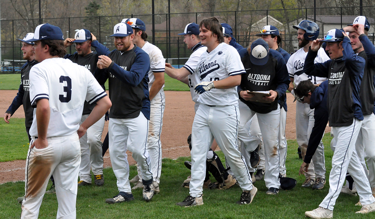 Photo (by Tim Belardi): Jared Ennis (center) and teammates celebrate the Lions' walkoff win in game two on Sunday.