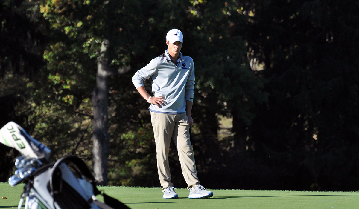 Photo: Junior Andrew Ferguson prepares to putt on the final hole of Monday's round.