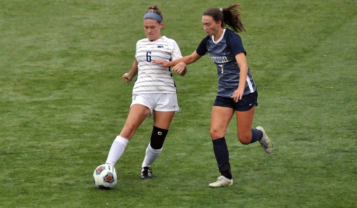 Photo: Sophomore Kayla Grove moves the ball in front of Penn State Behrend's Christine Patterson during Saturday's game.
