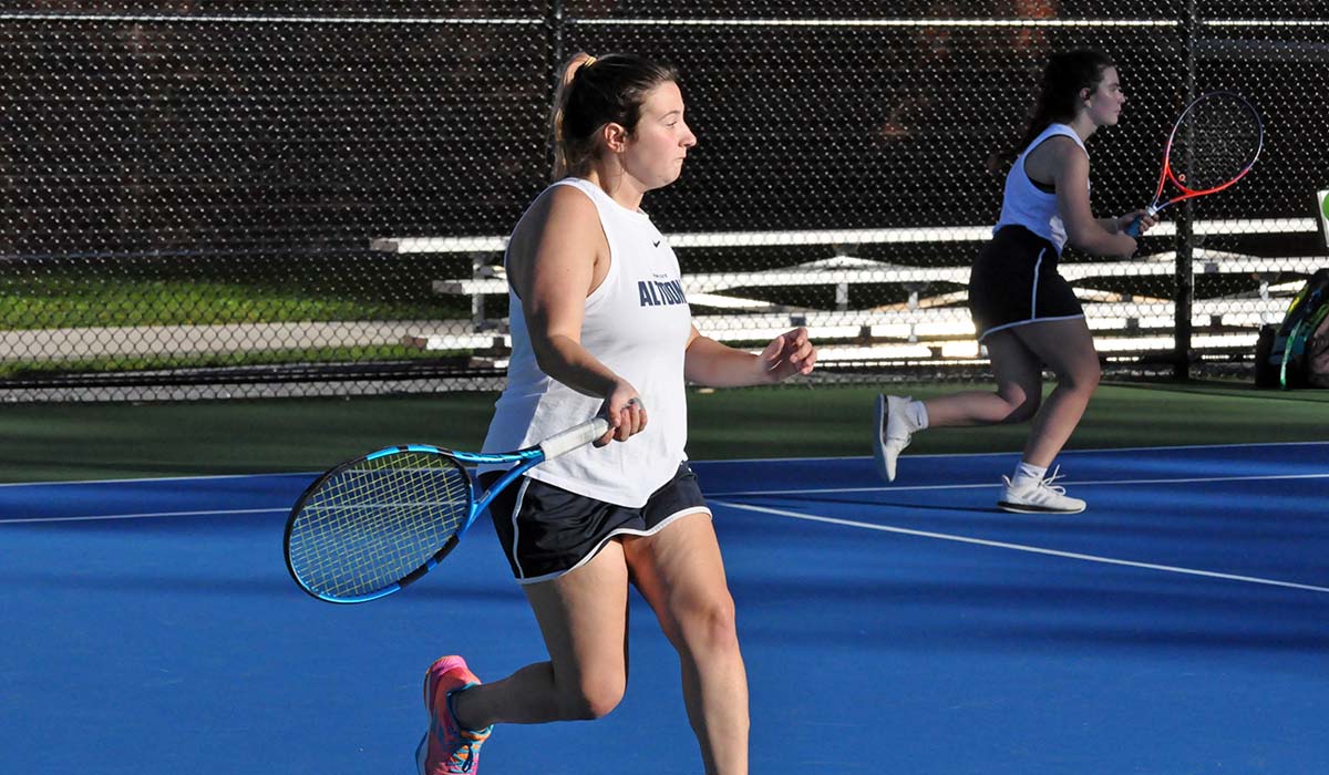Photo: Freshman Caitlyn Dale goes to the forehand during her doubles match on Friday against Penn State Behrend.