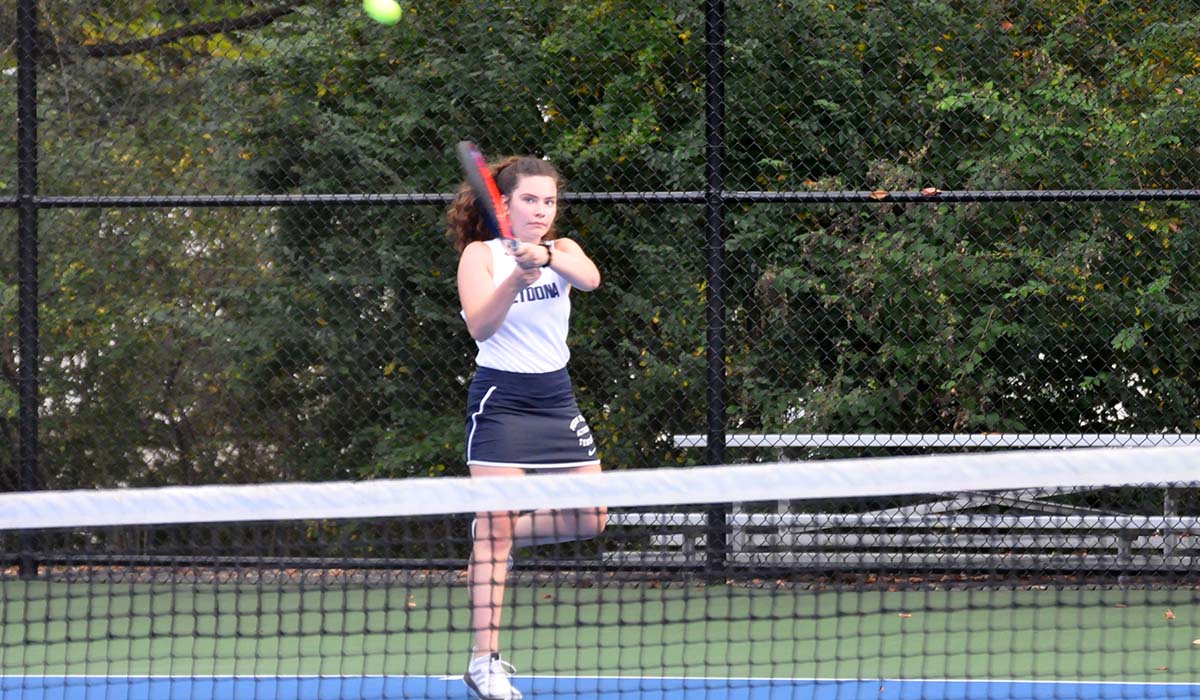 Photo: Freshman Emily Neil hits a backhand during her No. 1 singles match on Wednesday against Pitt-Greensburg.