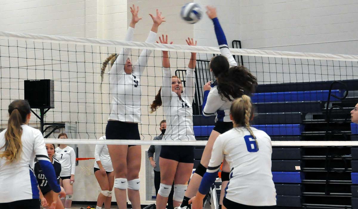 Photo: Alexis Cannistraci (left) and Karlie Feathers (right) go up for a block during Monday's win over Penn College.